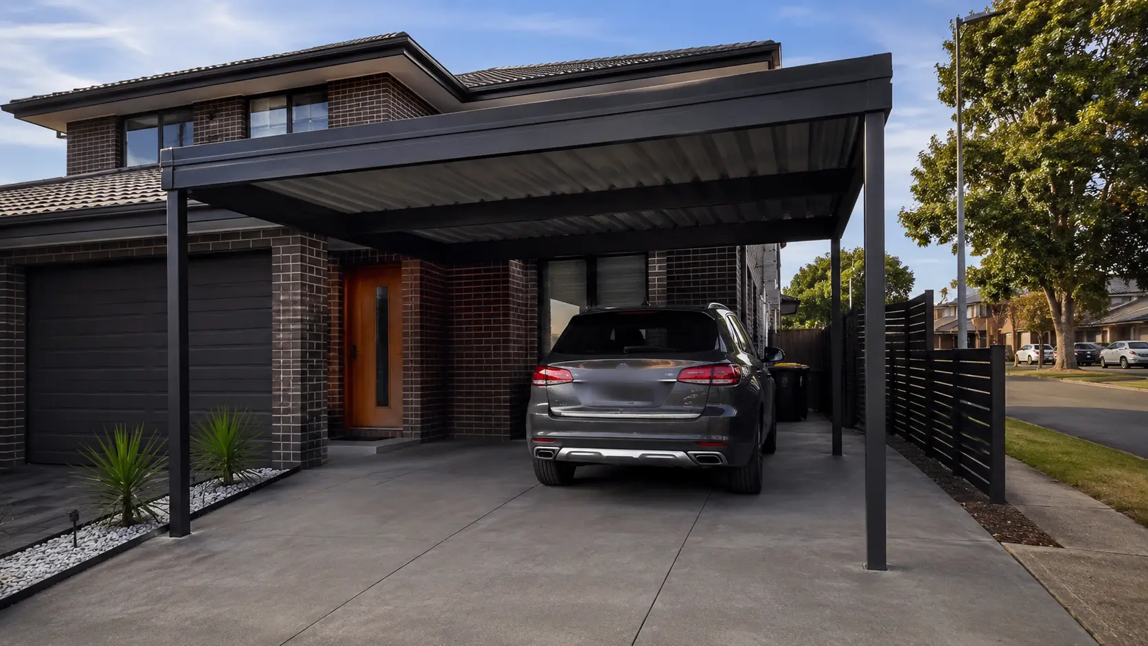 Modern steel-frame carport attached to a brick home in Melbourne